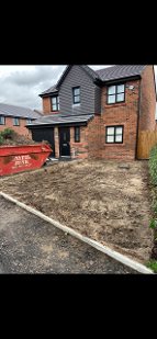 Image showing the driveway now completed excavated. There is a skip on the background showing the amount of earth that was removed. Resin bound surfaces in manchester