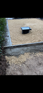 North West Image showing new pin kerbs that had been installed using concrete. The image also shows a new drainage access point that had been installed along with the first compacted layer of MOT type 3.